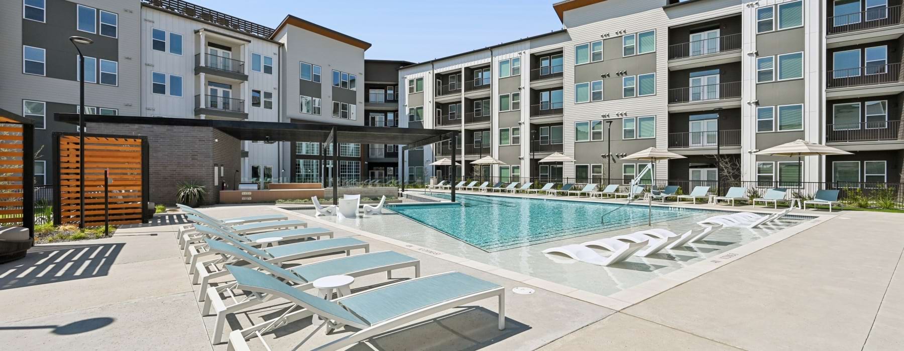 a pool with lounge chairs