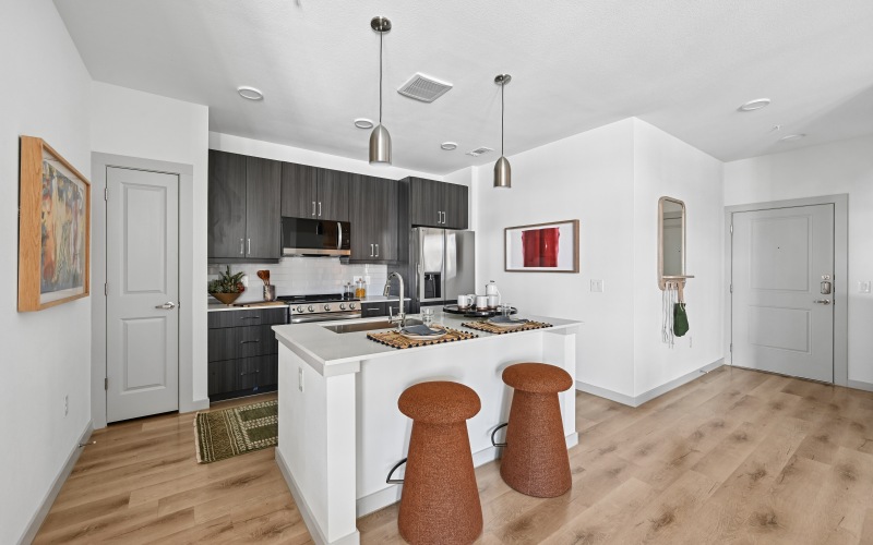 a kitchen with an island and chairs